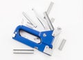 Blue staple gun with staples isolated over white Royalty Free Stock Photo