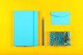 Blue stationery flat lay over yellow