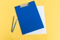 A blue stationery set as a template with a place to copy on a yellow background. pen and pencil Royalty Free Stock Photo