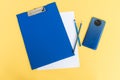 A blue stationery set as a template with a place to copy on a yellow background with a blue phone Royalty Free Stock Photo