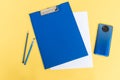 A blue stationery set as a template with a place to copy on a yellow background with a phone Royalty Free Stock Photo