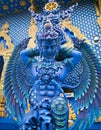 Blue statue of the Guard in Thai Lanna style - detail of exteror of Wat Rong Suea Ten, or Blue Temple in Chiang Rai Province,