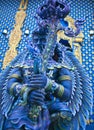 Blue statue of the Guard in Thai Lanna style - detail of exteror of Wat Rong Suea Ten, or Blue Temple in Chiang Rai, Northern