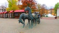 Blue statue of horses with a coach in a park in the city of Minsk, Belarus