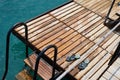Blue step-ins on the wooden sea pier stairs
