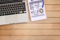 Blue stethoscope and laptop computer on office table background. Royalty Free Stock Photo