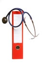 Blue stethoscope and red binder isolated on white Royalty Free Stock Photo