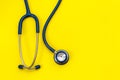 Blue stethoscope on yellow background. For check heart or health Royalty Free Stock Photo