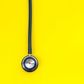 Blue stethoscope on yellow background. For check heart or health Royalty Free Stock Photo