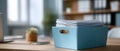 Blue storage box filled with stacked documents on wooden desk with blurred background Royalty Free Stock Photo