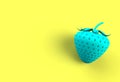 Blue strawberry on yellow background