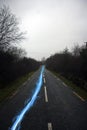 Blue streak of light on country road Royalty Free Stock Photo