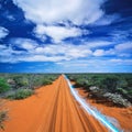 Blue streak of light on dirt road against cloudy sky Royalty Free Stock Photo