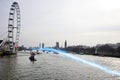 Blue streak of light passing over river Thames Royalty Free Stock Photo