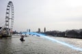 Blue streak of light passing over river Thames