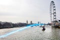 Blue streak of light passing over river Thames