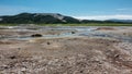 Blue streams from hot springs are visible in the caldera of an extinct volcano.