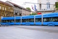 Blue streetcar side view with old residential building in Zagrab, Croatia