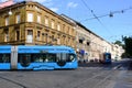 Blue streetcar side view with old residential building in Zagrab, Croatia