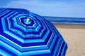 Blue striped beach umbrella Royalty Free Stock Photo