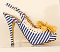 Blue striped shoe with cream bow.