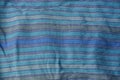 Blue striped texture of a cloth from a piece of crumpled clothes