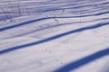 Blue stripes of shadows on the white snow Royalty Free Stock Photo