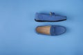 Blue suede man`s mocassin shoes over blue background