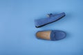 Blue suede man`s mocassin shoes over blue background