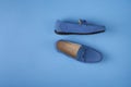 Blue suede man`s mocassin shoes over blue background