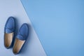 Blue suede man`s mocassin shoes over blue background