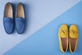 Blue suede man`s and yellow woman`s moccasins shoes over blue background Royalty Free Stock Photo