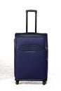 suitcase blue standing on white floor in front of white background Royalty Free Stock Photo