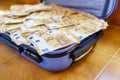 Blue suitcase full of fifty euro bills inside. Royalty Free Stock Photo