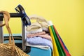 Blue suitcase with sun glasses, summer clothes, shoes and wicker bag on yellow background Royalty Free Stock Photo