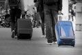 Blue Suitcase with tourist. Black and white background. Royalty Free Stock Photo