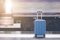 Blue suitcase at the train station with abstract light in retro Royalty Free Stock Photo