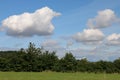 Blue summer sky with fluffy white cumulus clouds over the Shropshire landscape, UK