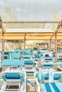 Blue sun loungers put in rows under transparent canopy Royalty Free Stock Photo