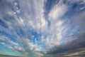 Blue sunset sky covered with white puffy clouds Royalty Free Stock Photo