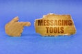 On a blue surface, a cardboard hand points to a sign with the inscription - Messaging Tools Royalty Free Stock Photo