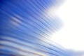 Blue surface of striped polycarbonate with a reflection of the blue distance of the city