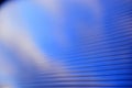 Blue surface of striped polycarbonate with a reflection of the blue distance of the city