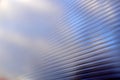 Blue surface of striped polycarbonate with a reflection of the blue distance of the city