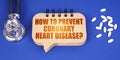 On the blue surface of the tablet, a notepad with the inscription - How to Prevent Coronary Heart Disease
