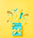 Blue surprise gift box on a yellow background Royalty Free Stock Photo