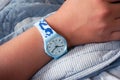 Blue Swatch watch on teenager`s hand Royalty Free Stock Photo