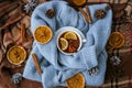 Blue sweater and cup of hot tea with lemon cinnamon sticks and anise star. Dry slices of citrus orange and cones. Hot Royalty Free Stock Photo