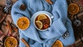 Blue sweater and cup of hot tea with lemon cinnamon sticks and anise star. Dry slices of citrus orange and cones. Hot Royalty Free Stock Photo