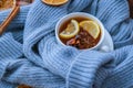 Blue sweater and cup of hot tea with lemon cinnamon sticks and anise star. Dry slices of citrus orange and cones. Hot Royalty Free Stock Photo